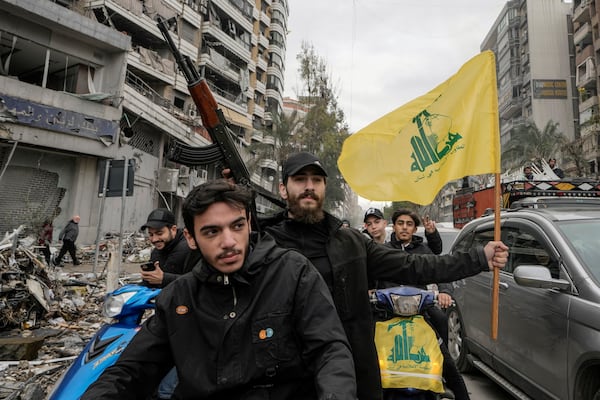 Hezbollah supporters celebrate as they return to Dahiyeh, in Beirut, Lebanon, following a ceasefire between Israel and Hezbollah that went into effect on Wednesday, Nov. 27, 2024. (AP Photo/Bilal Hussein)