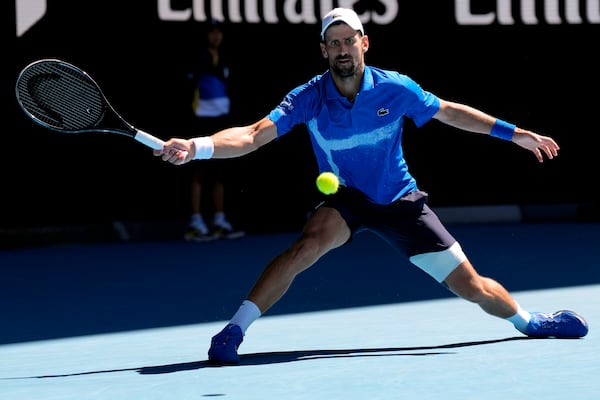 Novak Djokovic of Serbia plays a forehand return to Alexander Zverev of Germany during their semifinal match at the Australian Open tennis championship in Melbourne, Australia, Friday, Jan. 24, 2025. (AP Photo/Ng Han Guan)