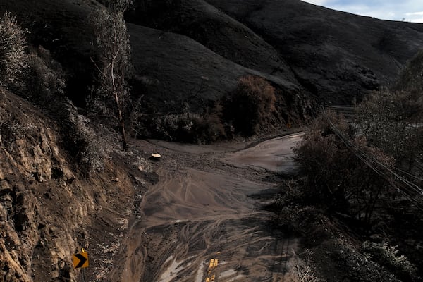 Mud covers Topanga Canyon Rd. on the Palisades Fire burn area after a series of weekend storms Monday, Jan. 27, 2025 near Malibu, Calif. (AP Photo/Jae C. Hong)