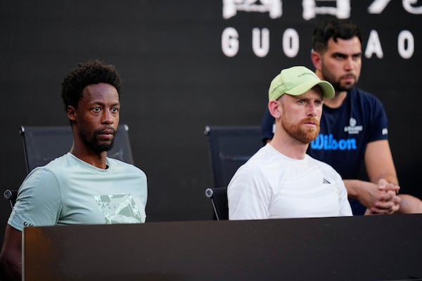 Gael Monfils, left, watches his wife, Elina Svitolina of Ukraine, from the coaches box, play Jasmine Paolini of Italy in their third round match at the Australian Open tennis championship in Melbourne, Australia, Saturday, Jan. 18, 2025. (AP Photo/Vincent Thian)