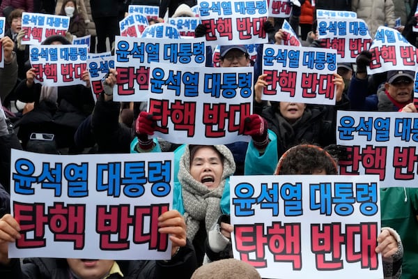 Supporters for impeached South Korean President Yoon Suk Yeol stage a rally against his impeachment near the Constitutional Court in Seoul, South Korea, Monday, Dec. 16, 2024. The signs read "Oppose the impeachment of President Yoon Suk Yeol." (AP Photo/Ahn Young-joon)