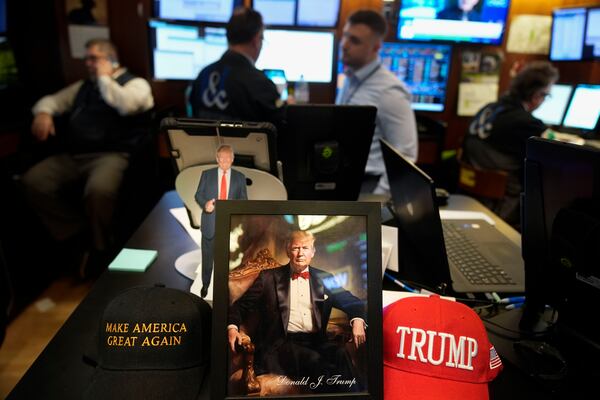 Paraphernalia supporting President Donald Trump is displayed at a post on the floor of the New York Stock Exchange in New York, Tuesday, Jan. 21, 2025. (AP Photo/Seth Wenig)