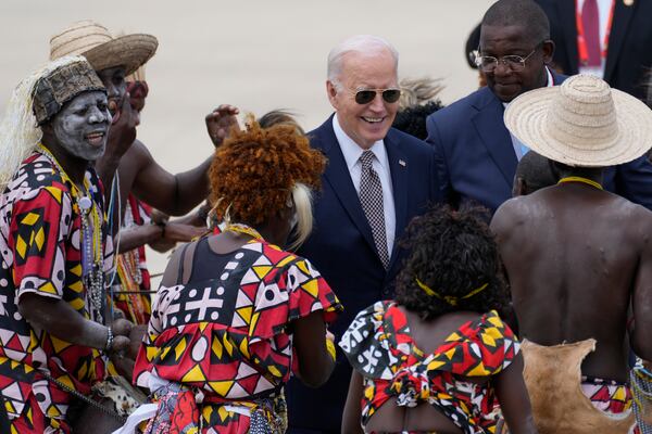 President Joe Biden watches a traditional dance after arriving at Catumbela airport in Angola on Wednesday, Dec. 4, 2024. (AP Photo/Ben Curtis)