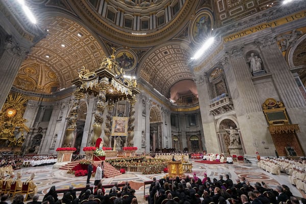 Pope Francis presides over the Christmas Eve Mass in St. Peter's Basilica at The Vatican, Tuesday, Dec. 24, 2024, after opening the basilica's holy door marking the start of the Catholic jubilar year 2025. (AP Photo/Andrew Medichini)