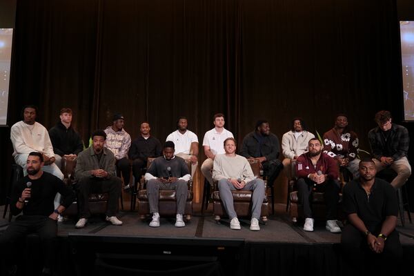 A group of college athletes gather and speak on stage during a meeting of the players association for college athletes ahead of the college football's national title game, Saturday, Jan. 18, 2025, in Atlanta. (AP Photo/Brynn Anderson)