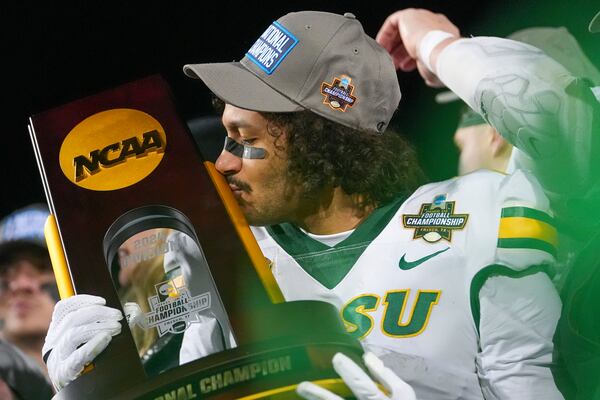 North Dakota State wide receiver Braylon Henderson kisses the trophy following the FCS Championship NCAA college football game against Montana State, Monday, Jan. 6, 2025, in Frisco, Texas. North Dakota State won 35-32. (AP Photo/Julio Cortez)