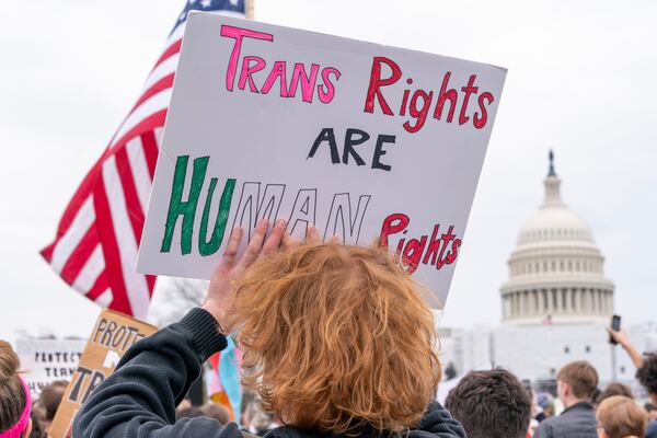 FILE - People attend a rally as part of a Transgender Day of Visibility, Friday, March 31, 2023, by the Capitol in Washington. (AP Photo/Jacquelyn Martin, File)