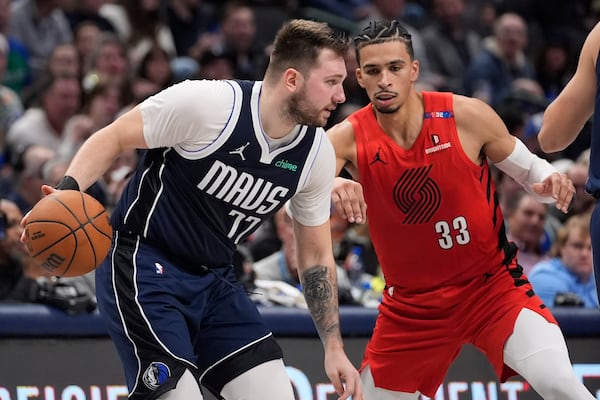 Dallas Mavericks guard Luka Doncic (77) dribbles against Portland Trail Blazers forward Toumani Camara (33) during the first half of an NBA basketball game, Monday, Dec. 23, 2024, in Dallas. (AP Photo/LM Otero)