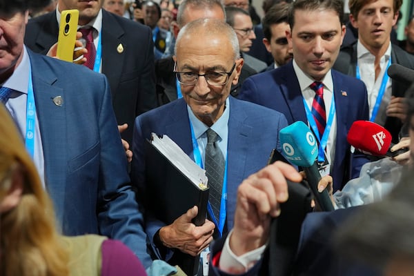 John Podesta, U.S. climate envoy, walks through a crowd during the COP29 U.N. Climate Summit, Saturday, Nov. 23, 2024, in Baku, Azerbaijan. (AP Photo/Peter Dejong)