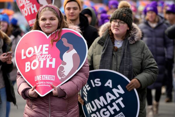 People participating in the annual March for Life, walk from the Washington Monument to the Supreme Court, Friday, Jan. 24, 2025, in Washington.(AP Photo/Ben Curtis)