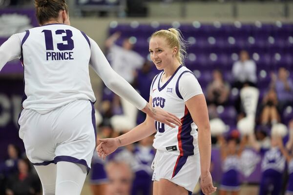 TCU guard Hailey Van Lith, right, is congratulated by teammate center Sedona Prince (13) during the second half of an NCAA college basketball game against Idaho State, Sunday, Nov. 24, 2024, in Fort Worth, Texas. (AP Photo/LM Otero)