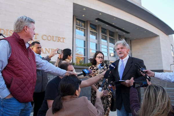 John McCarthy, state's attorney for Montgomery County, right, speaks to reporters outside of the Montgomery County District Court in Rockville, Md., Tuesday, Nov. 26, 2024. (AP Photo/Stephanie Scarbrough)