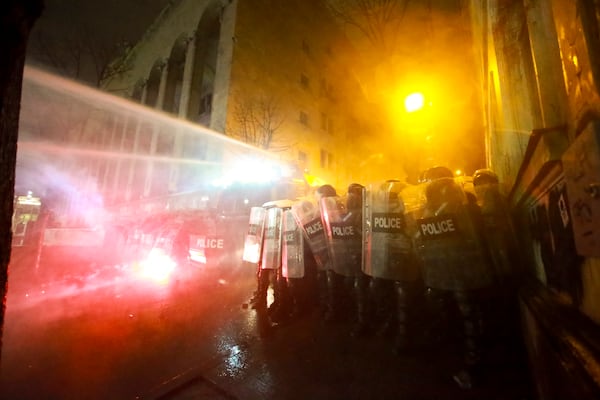 Police use a water cannon to stop protesters rallying outside the parliament's building to continue protests against the government's decision to suspend negotiations on joining the European Union in Tbilisi, Georgia, on Monday, Dec. 2, 2024.(AP Photo/Zurab Tsertsvadze)