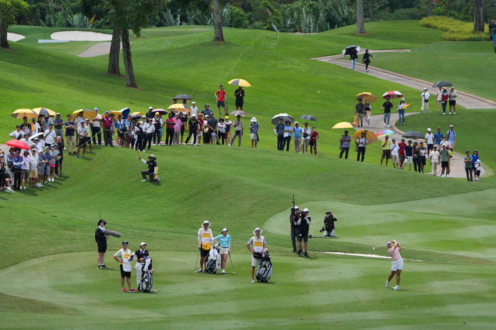 Ryu Haeran of South Korea's, right, watches her fairway shot on the 14th hole during the LPGA Tour's Maybank Championship at Kuala Lumpur Golf and Country club in Kuala Lumpur, Sunday, Oct. 27, 2024. (AP Photo/Vincent Thian)