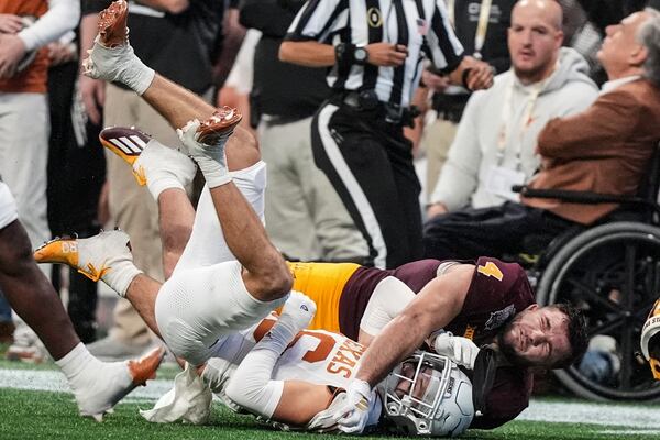 Texas defensive back Michael Taaffe (16) hits Arizona State running back Cam Skattebo (4) during the second half in the quarterfinals of a College Football Playoff game, Wednesday, Jan. 1, 2025, in Atlanta. (AP Photo/Brynn Anderson)