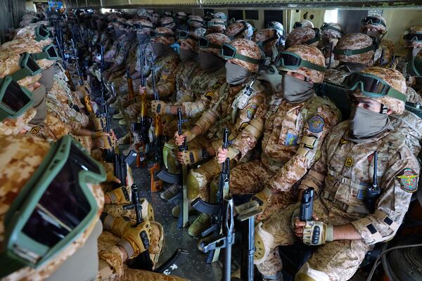 FILE - In this photo released by the Tasnim News Agency, the Iranian Revolutionary Guard troops travel in a plane from Rasht in northern Iran, to Kermanshah in western Iran, during a drill on Jan. 5, 2025. (Hossein Zohrevand/Tasnim News Agency via AP, File)