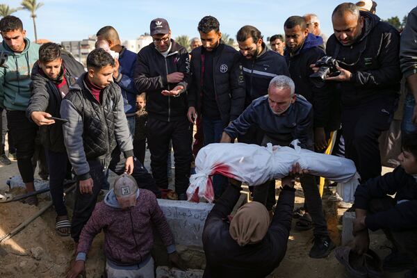 Palestinians bury the body of a relative who was killed in the Israeli bombardment of the Gaza Strip, Tuesday, Jan. 14, 2025. (AP Photo/Abdel Kareem Hana)