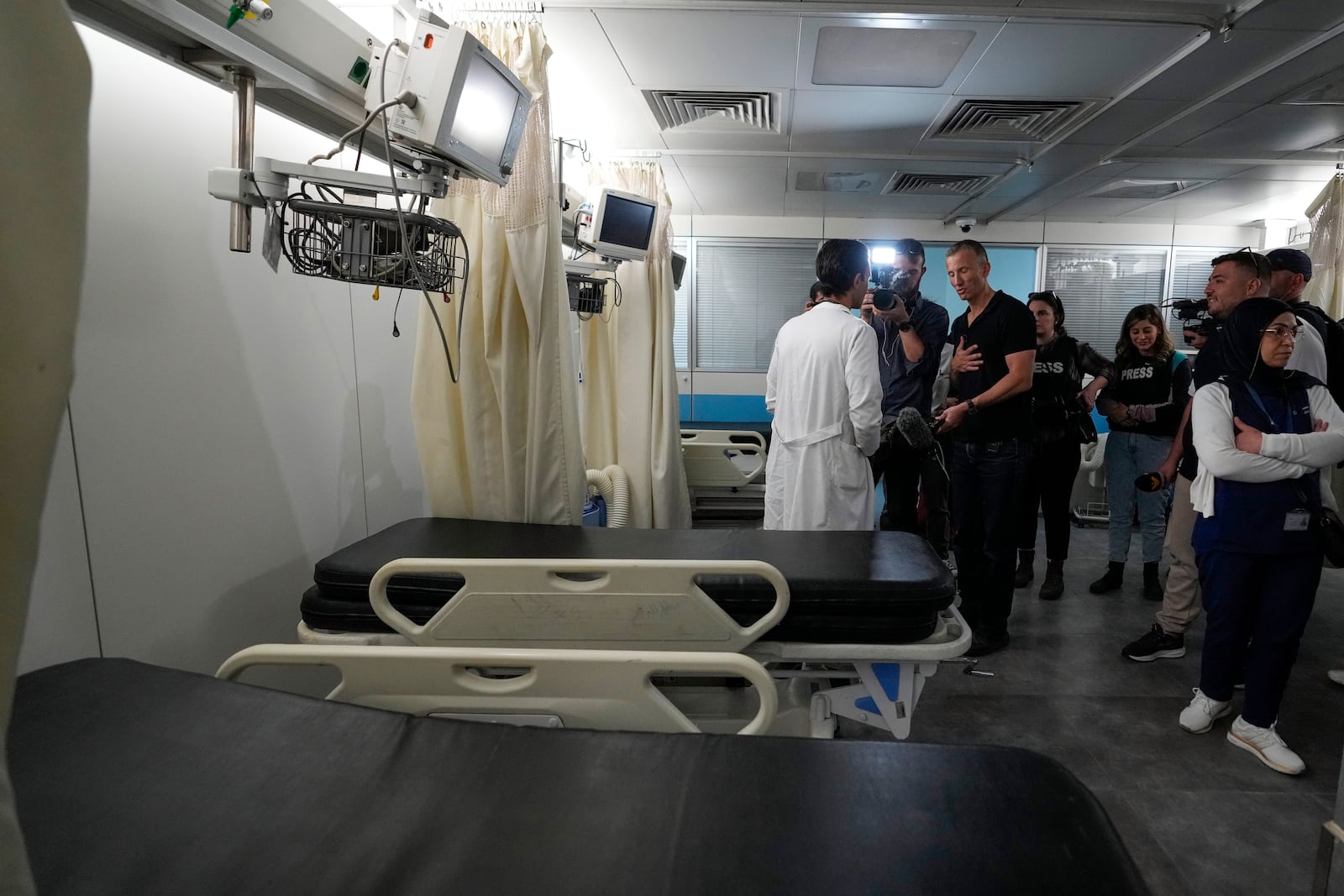 Foreign and local journalists take a tour inside Sahel General Hospital, in Dahiyeh, Beirut, Lebanon, Tuesday, Oct. 22, 2024, a day after the Israeli army said that Hezbollah is storing hundreds of millions of dollars in cash and gold under the hospital. (AP Photo/Hassan Ammar)