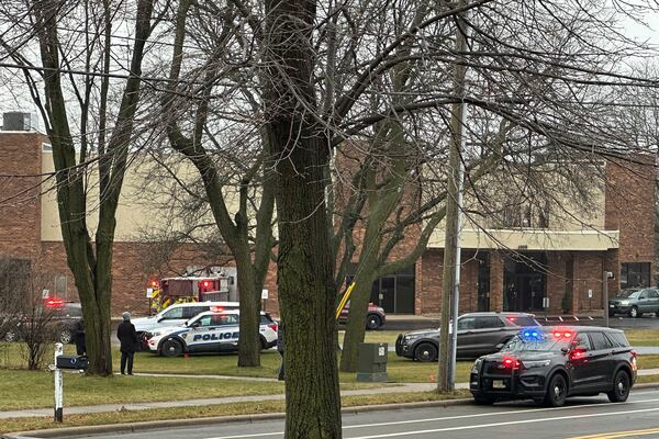 Emergency vehicles are parked outside the Abundant Life Christian School in Madison, Wis., where multiple injuries were reported following a shooting, Monday, Dec. 16, 2024. (AP Photo/Kathleen Foody)