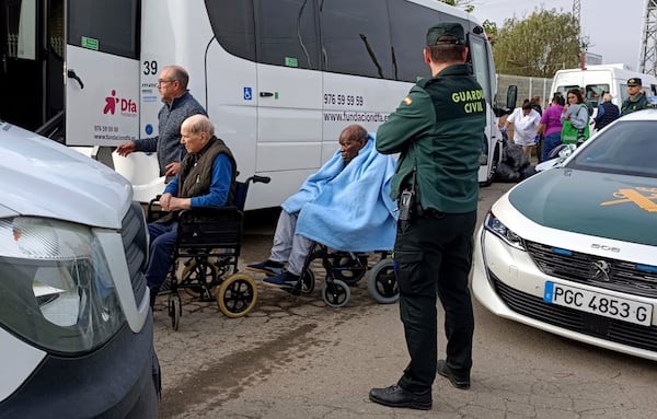 Residents are moved out of the nursing home where least 10 people have died in a fire in Zaragoza, Spain, Friday, Nov. 15, 2024. (AP Photo/Ferran Mallol)