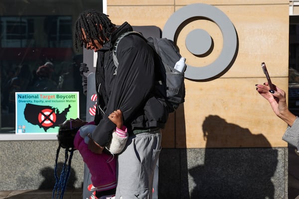 Assata Armstrong, left, 7, greets her brother PJ Pounds before a news conference outside Target Corporation's headquarters Thursday, Jan. 30, 2025, in Minneapolis, Minn. (AP Photo/Ellen Schmidt)