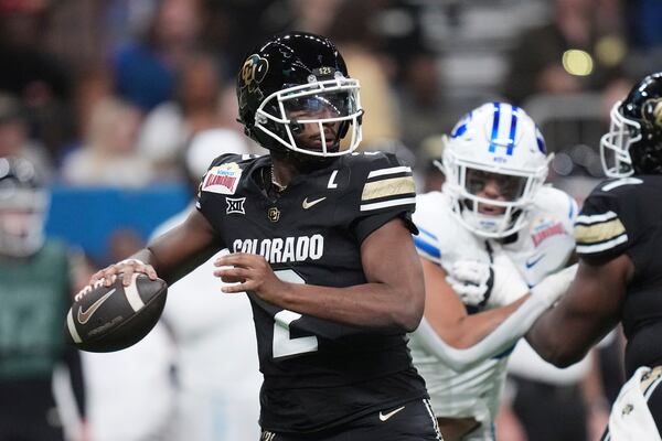 Colorado quarterback Shedeur Sanders (2) looks to throw against BYU during the first half of the Alamo Bowl NCAA college football game, Saturday, Dec. 28, 2024, in San Antonio. (AP Photo/Eric Gay)