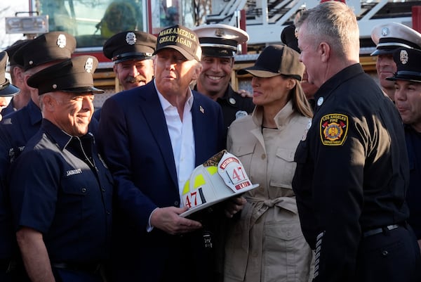 FILE - President Donald Trump and first lady Melania Trump talk with Los Angeles firefighters as they tour the Pacific Palisades neighborhood affected by recent wildfires in Los Angeles, Friday, Jan. 24, 2025. (AP Photo/Mark Schiefelbein, File)