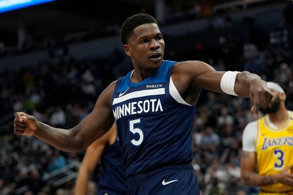 Minnesota Timberwolves guard Anthony Edwards (5) reacts after making a basket and being fouled during the first half of an NBA basketball game against the Los Angeles Lakers, Friday, Dec. 13, 2024, in Minneapolis. (AP Photo/Abbie Parr)