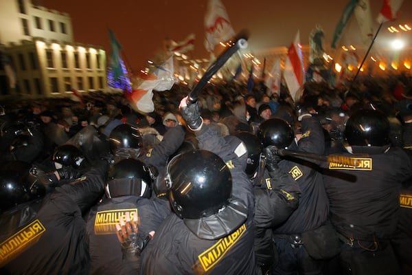 FILE - Riot police clash with demonstrators outside a government building after President Alexander Lukashenko was declared the winner of an election to a fourth term, in the capital of Minsk, Belarus, on Dec. 19, 2010. (AP Photo, File)