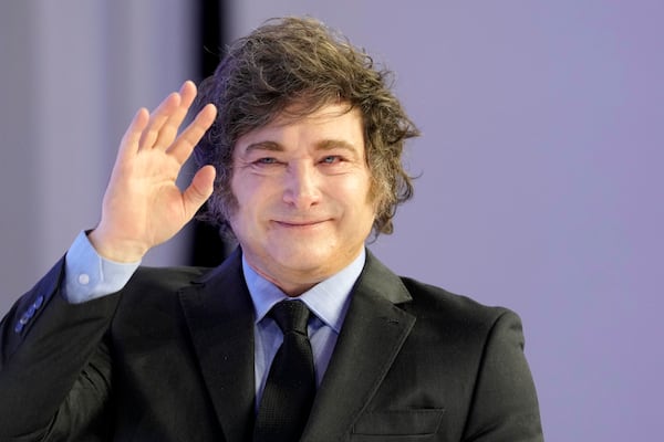 Argentina's President Javier Milei waves as he arrives for his speech at the Annual Meeting of World Economic Forum in Davos, Switzerland, Thursday, Jan. 23, 2025. (AP Photo/Markus Schreiber)