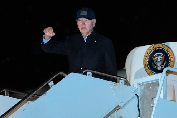 President Joe Biden waves as he boards Air Force One at Nantucket Memorial Airport, Mass., Saturday, Nov. 30, 2024, en route to Washington. (AP Photo/Jose Luis Magana)