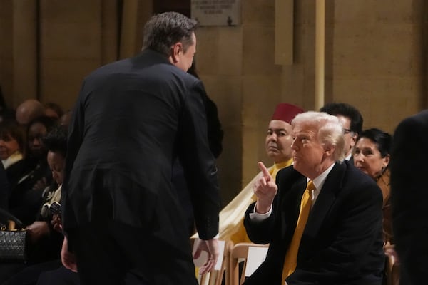 President-elect Donald Trump points to Elon Musk in Notre Dame Cathedral as France's iconic cathedral is formally reopening its doors for the first time since a devastating fire nearly destroyed the 861-year-old landmark in 2019, Saturday, Dec. 7, 2024 in Paris. (AP Photo/Thibault Camus, Pool)