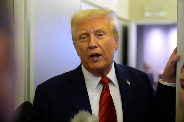 President Donald Trump speaks to reporters aboard Air Force One en route from Miami to Joint Base Andrews, Md., Monday, Jan. 27, 2025. (AP Photo/Mark Schiefelbein)