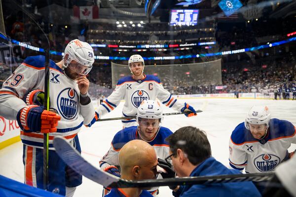 Edmonton Oilers defenseman Darnell Nurse (25) is attended to by medical personnel and teammates after colliding with Toronto Maple Leafs right wing Ryan Reaves (75) during the second period of an NHL hockey game, Saturday, Nov. 16, 2024 in Toronto. (Christopher Katsarov/The Canadian Press via AP)