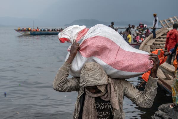 People fleeing M-23 rebel advances arrive by boat in Goma, Democratic Republic of the Congo, Wednesday, Jan. 22, 2025. (AP Photo/Moses Sawasawa)