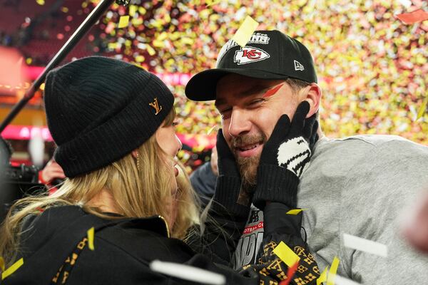 Kansas City Chiefs tight end Travis Kelce, right, is congratulated by Taylor Swift as they celebrate the Chiefs victory over the Buffalo Bills in the AFC Championship NFL football game, Sunday, Jan. 26, 2025, in Kansas City, Mo. (AP Photo/Charlie Riedel)