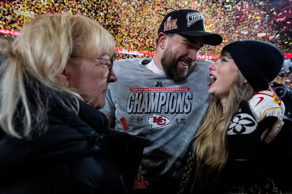 Donna Kelce stands with her son Kansas City Chiefs tight end Travis Kelce and Taylor Swift after the AFC Championship NFL football game against the Buffalo Bills, Sunday, Jan. 26, 2025, in Kansas City, Mo. (AP Photo/Ashley Landis)