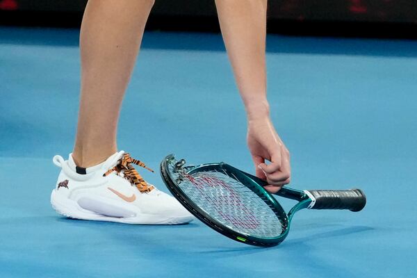 Aryna Sabalenka of Belarus collects her racket after losing the women's singles final against Madison Keys of the U.S. at the Australian Open tennis championship in Melbourne, Australia, Saturday, Jan. 25, 2025. (AP Photo/Asanka Brendon Ratnayake)