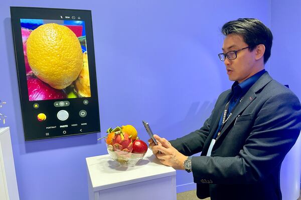 A Samsung employee shows off the new Samsung Galaxy S25 phone, with advanced camera and artificial intelligence capabilities, are unveiled at a media preview event in San Jose, Calif. on Tuesday, Jan. 21, 2025. (AP Photo/Haven Daily)