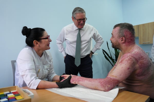 Britain's Prime Minister Keir Starmer visits a hospital as a staff member meets with an injured patient, in Kyiv, Ukraine Thursday, Jan. 16, 2025. (Carl Court/Pool Photo via AP)