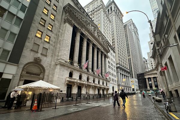 People walk past the New York Stock Exchange on Tuesday, Nov. 26 2024. (AP Photo/Peter Morgan)