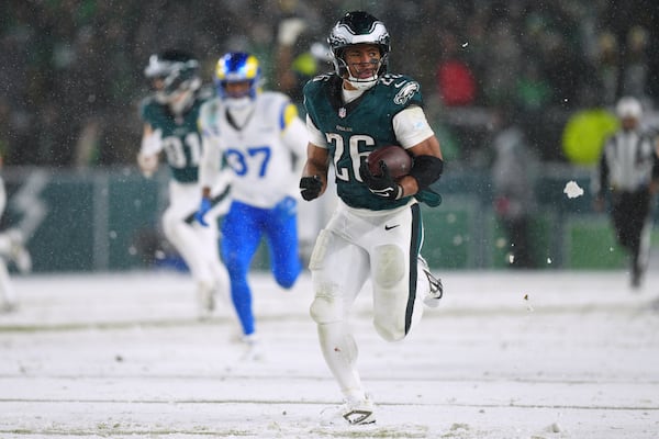 Philadelphia Eagles running back Saquon Barkley (26) runs the ball for a touchdown during the second half of an NFL football NFC divisional playoff game against the Los Angeles Rams on Sunday, Jan. 19, 2025, in Philadelphia. (AP Photo/Derik Hamilton)