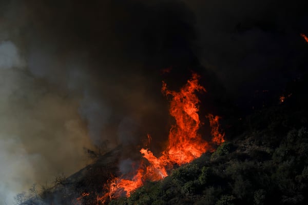 The Palisades Fire continues to burn in the outskirts of the Pacific Palisades neighborhood of Los Angeles, Friday, Jan. 10, 2025. (AP Photo/Eric Thayer)