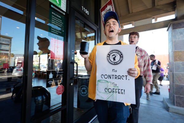 Starbuck workers picket outside of a closed Starbucks on Friday, Dec. 20, 2024, in Burbank, Calif. (AP Photo/Damian Dovarganes)