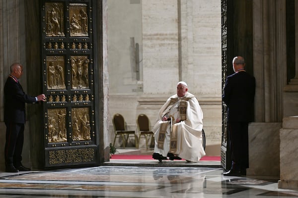 Pope Francis opens the Holy Door of St Peter's Basilica to mark the start of the Catholic Jubilee Year, at the Vatican, Dec. 24, 2024. (Alberto Pizzoli/Pool Photo via AP)