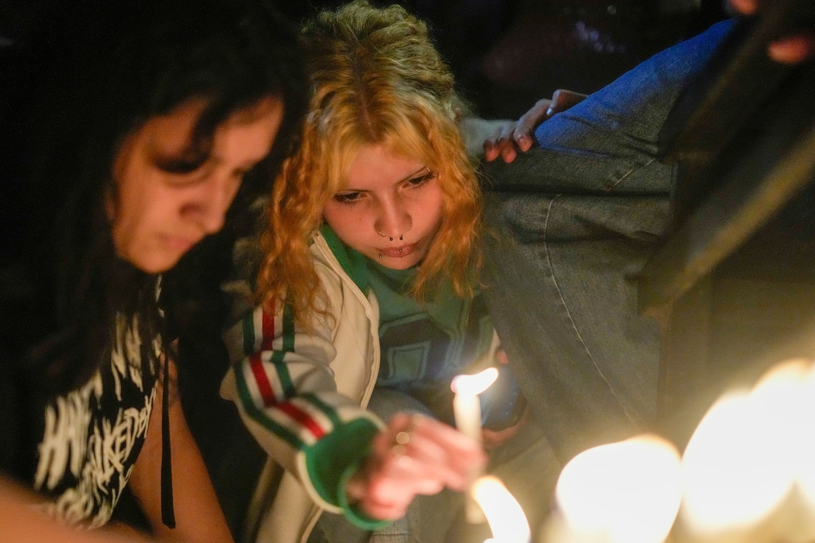 Fans light candles outside the hotel where former One Direction singer Liam Payne was found dead after he fell from a balcony in Buenos Aires, Argentina, Wednesday, Oct. 16, 2024. (AP Photo/Natacha Pisarenko)