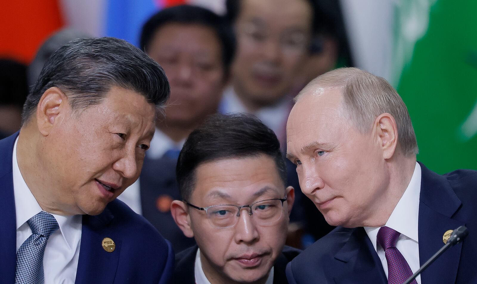 Chinese President Xi Jinping, left, and Russian President Vladimir Putin, right, speak during Outreach/BRICS Plus format session at BRICS Summit in Kazan, Russia, Thursday, Oct. 24, 2024. (Maxim Shemetov, Pool Photo via AP)