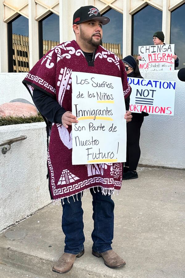 Javier Terrazas, who has a school age daughter in south Oklahoma City holds a sign to protest Oklahoma's Board of Education considering a rule that would require parents enrolling children in public schools to provide proof of their child's U.S. citizenship or legal immigration status on Tuesday, Jan. 28, 2025 in Oklahoma City, Oka. (AP Photo/Sean Murphy)