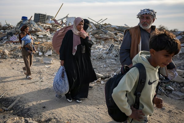 Members of the Abu Sheiban family return to their home in Rafah, days after the ceasefire deal between Israel and Hamas, southern Gaza Strip, Tuesday, Jan. 21, 2025. (AP Photo/Abdel Kareem Hana)