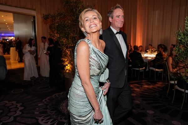 Sharon Stone, left, and Jim Osborne arrive at the 82nd Golden Globes on Sunday, Jan. 5, 2025, at the Beverly Hilton in Beverly Hills, Calif. (AP Photo/Chris Pizzello)